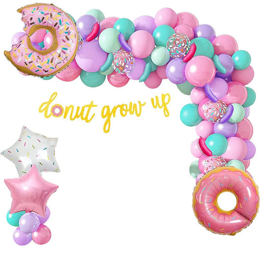 Donut grow up balloon arch with sprinkle and pink foil star balloons on white background display