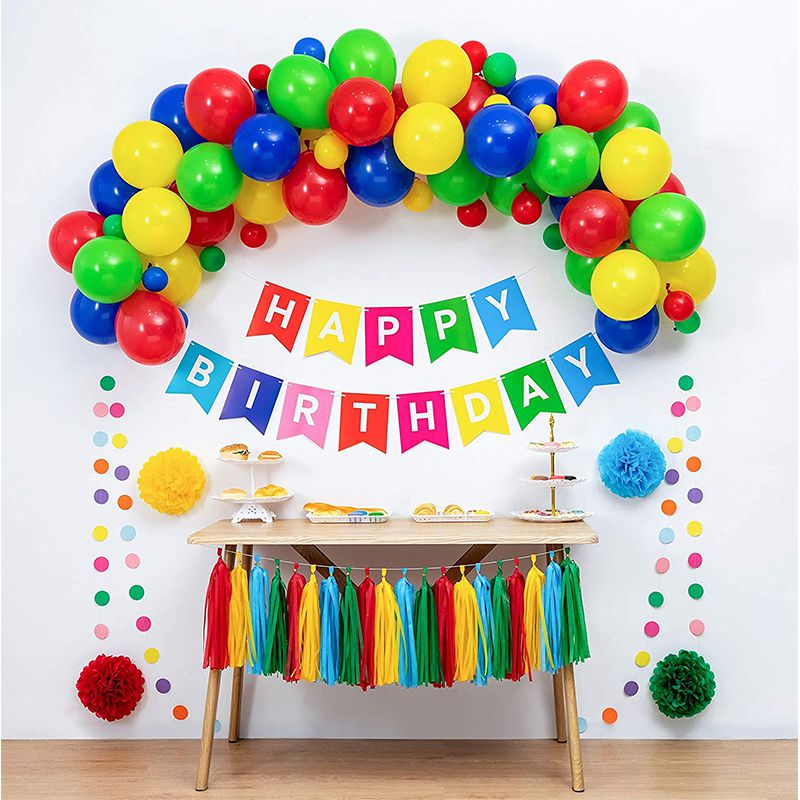rainbow happy birthday balloon and bunting with table and rainbow coloured tassels 