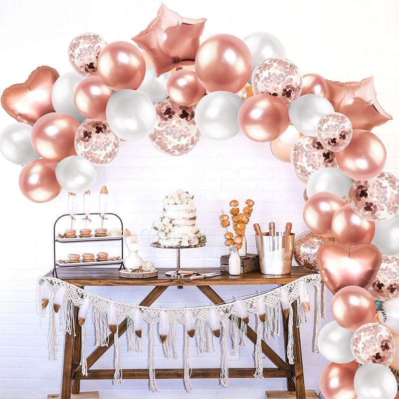 rose gold hearts balloon arch display with table setup 
