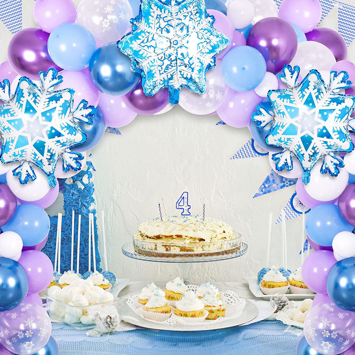 snowy winter balloon arch on wall display for a 4th birthday party 