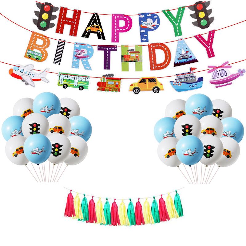 Happy birthday banner with tassels red yellow and green and transportation balloons 